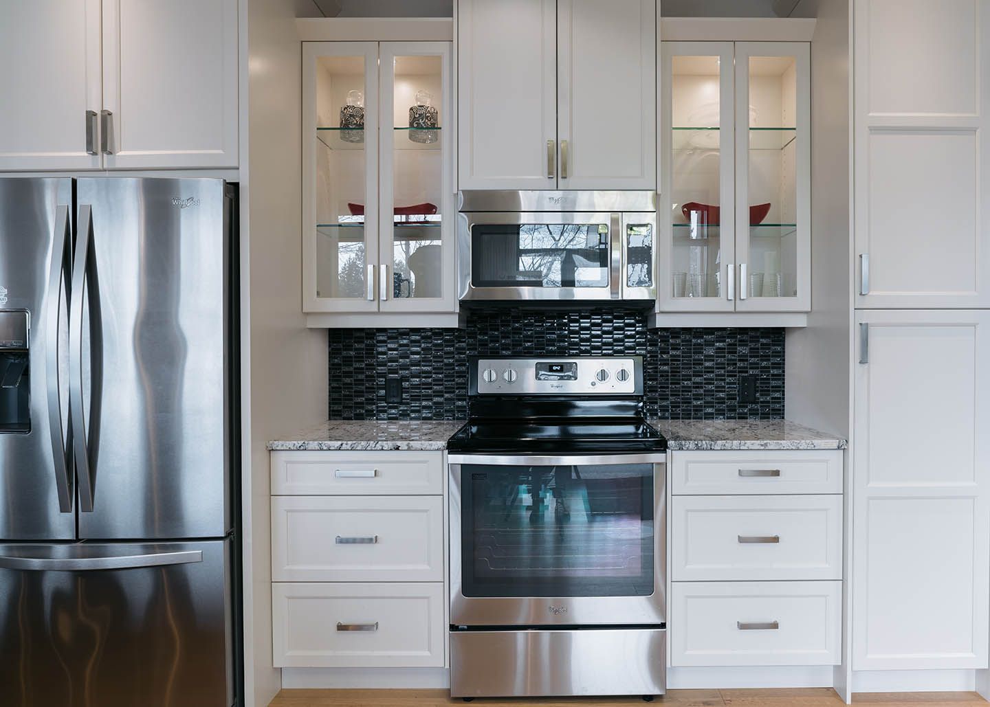 Stainless steel appliances and white cabinets in a kitchen