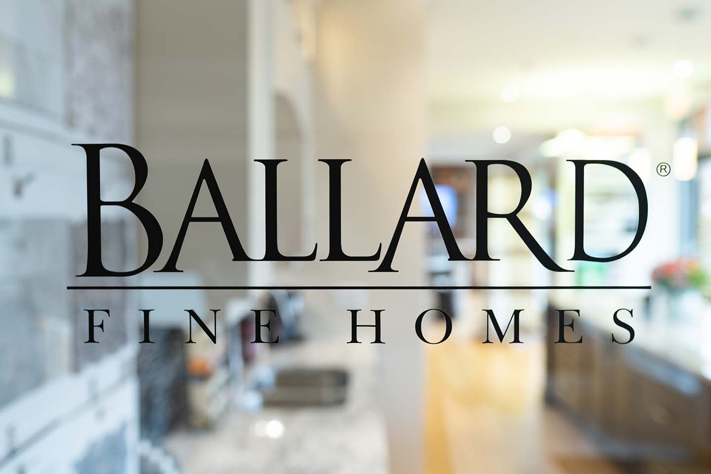 Close up of Ballard Fine Homes logo on glass door