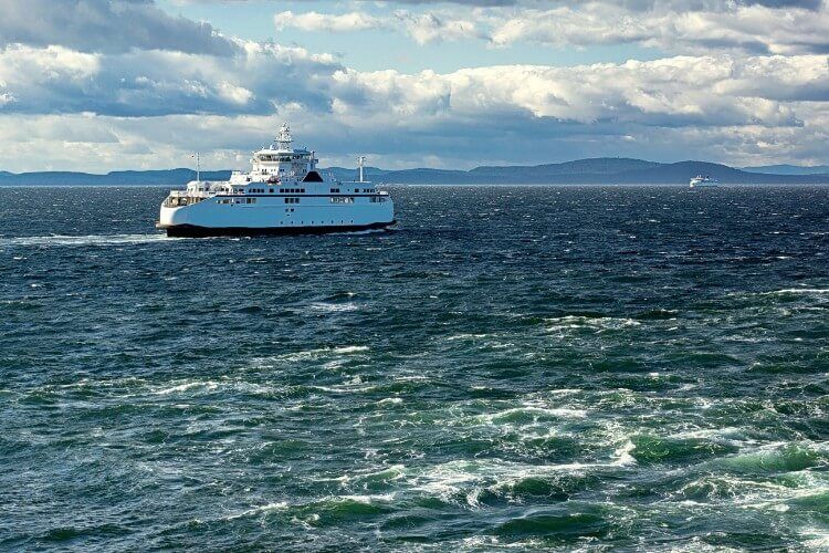 BC Ferry crossing ocean with blue skies in the background