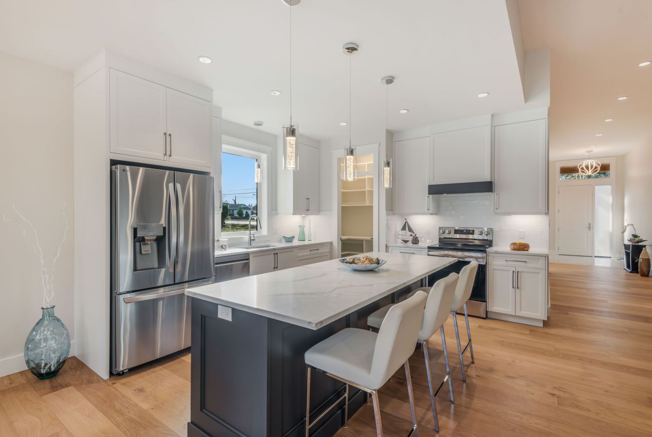 Kitchen with metal appliances and wooden flooring
