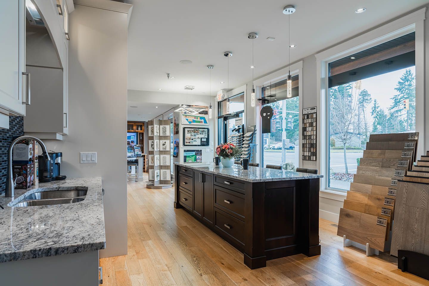 Interior of Ballard Fine Homes showroom showing bathroom fixture samples and large cabinet