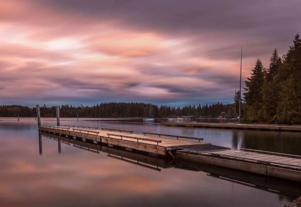 Pier on Comox lake with vibrant sunset in the background near Courtenay BC