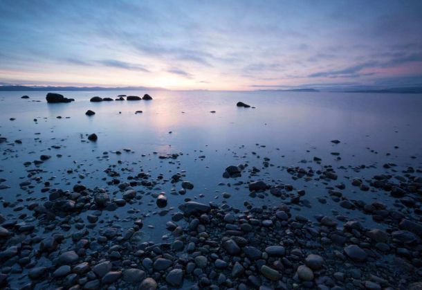 Photo of Point Holms shore with sunset in the background in the comox valley near Courtenay BC