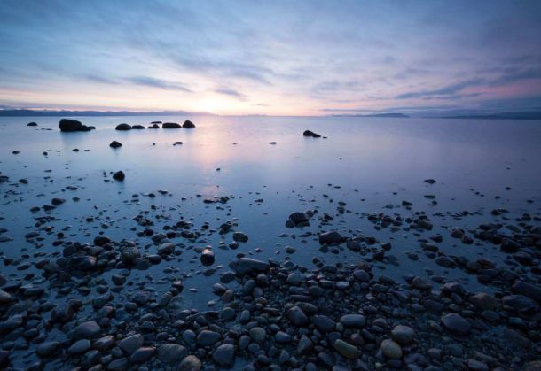 Photo of Point Holms shore with sunset in the background in the comox valley near Courtenay BC