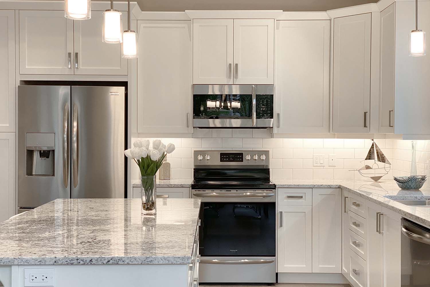 Kitchen with marble countertops and stainless steel oven.