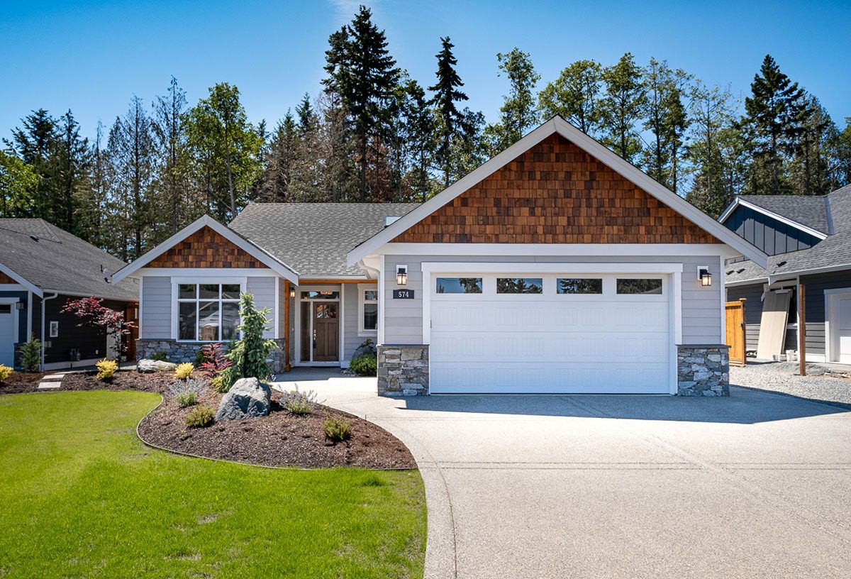 Exterior of grey house with large white garage door