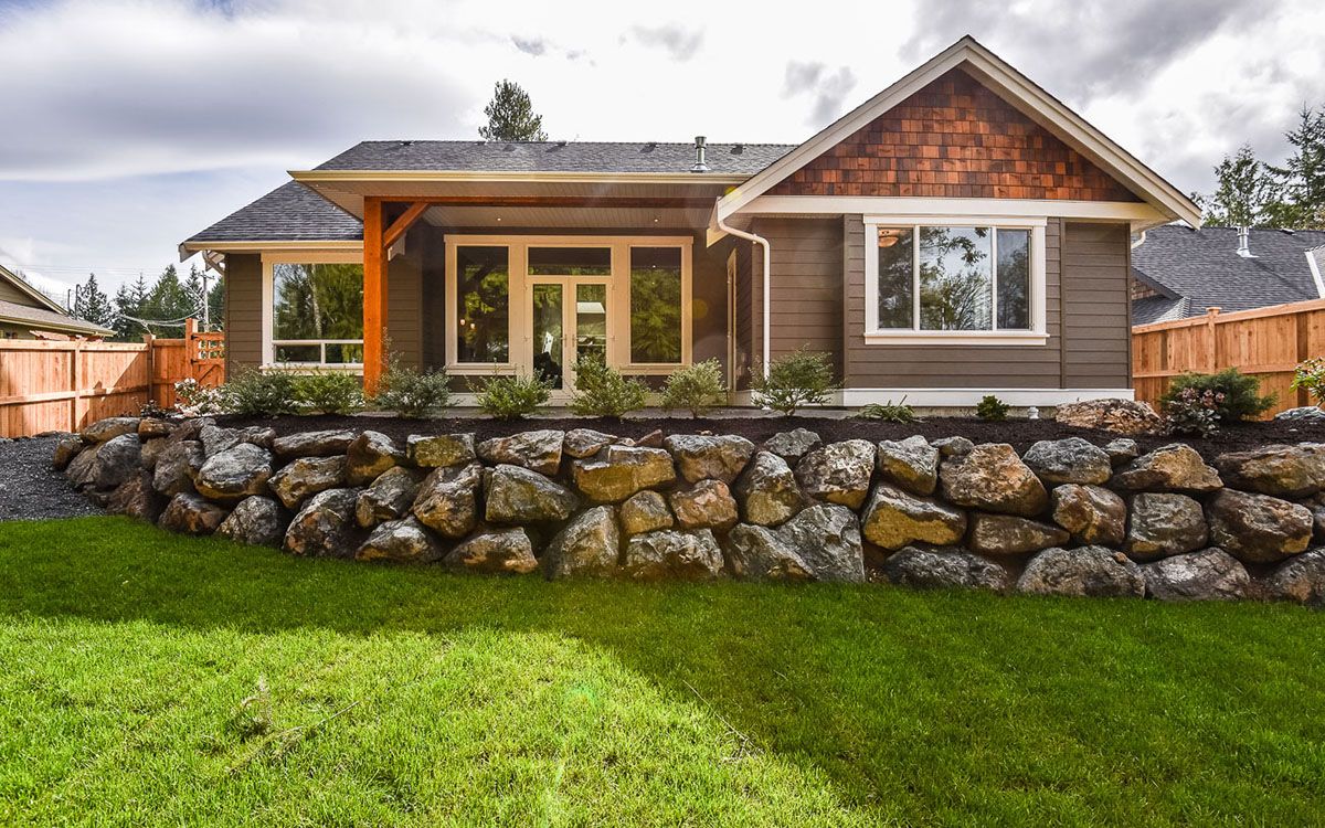 Landscaped back yard with grass and rocks