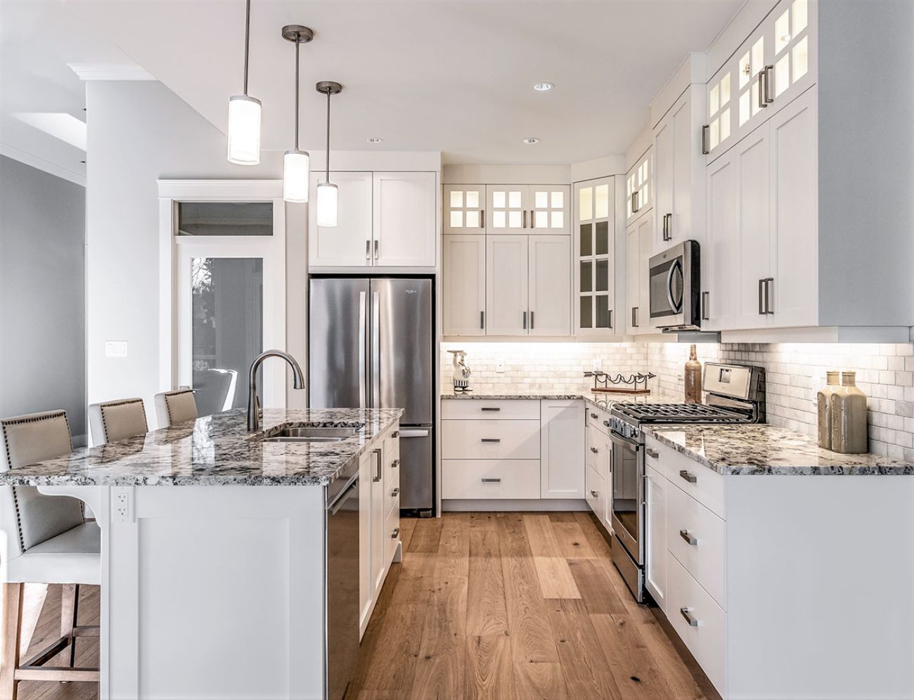 Kitchen with metal appliances and wooden flooring