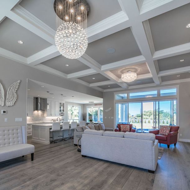 Wide view of living room with kitchen behind it