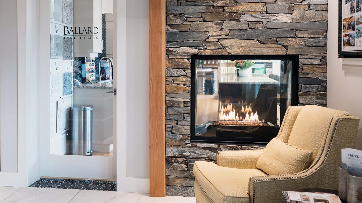 A beige seat in front of a lit fire place