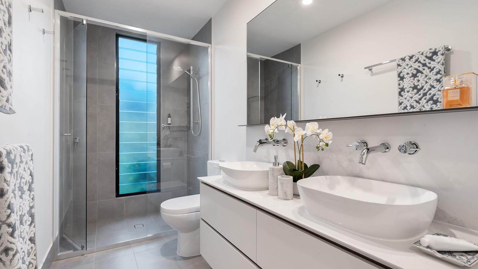 Photo of an elegantly designed bathroom with white orchids