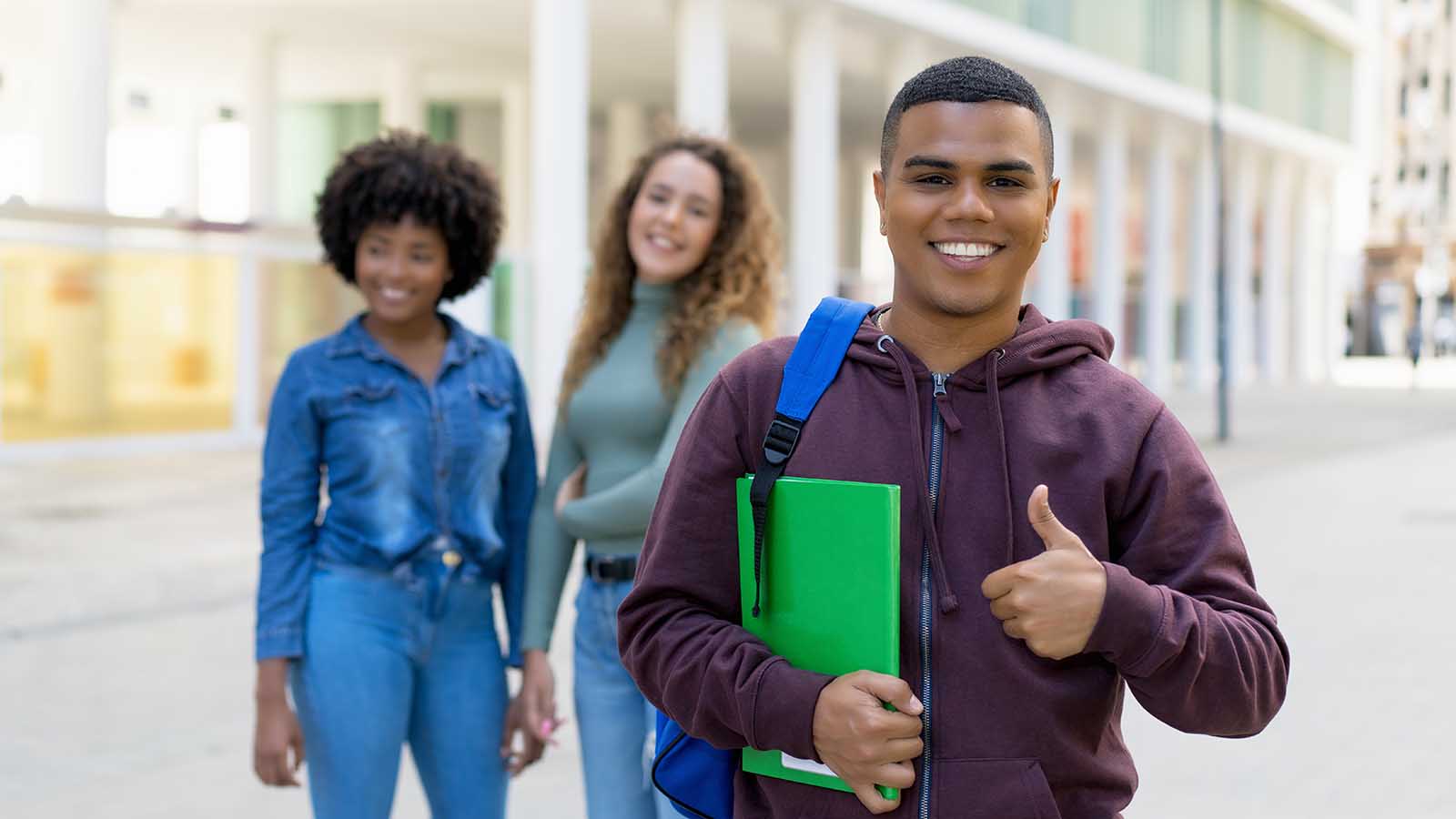 Happy students with one in particular giving a thumbs up