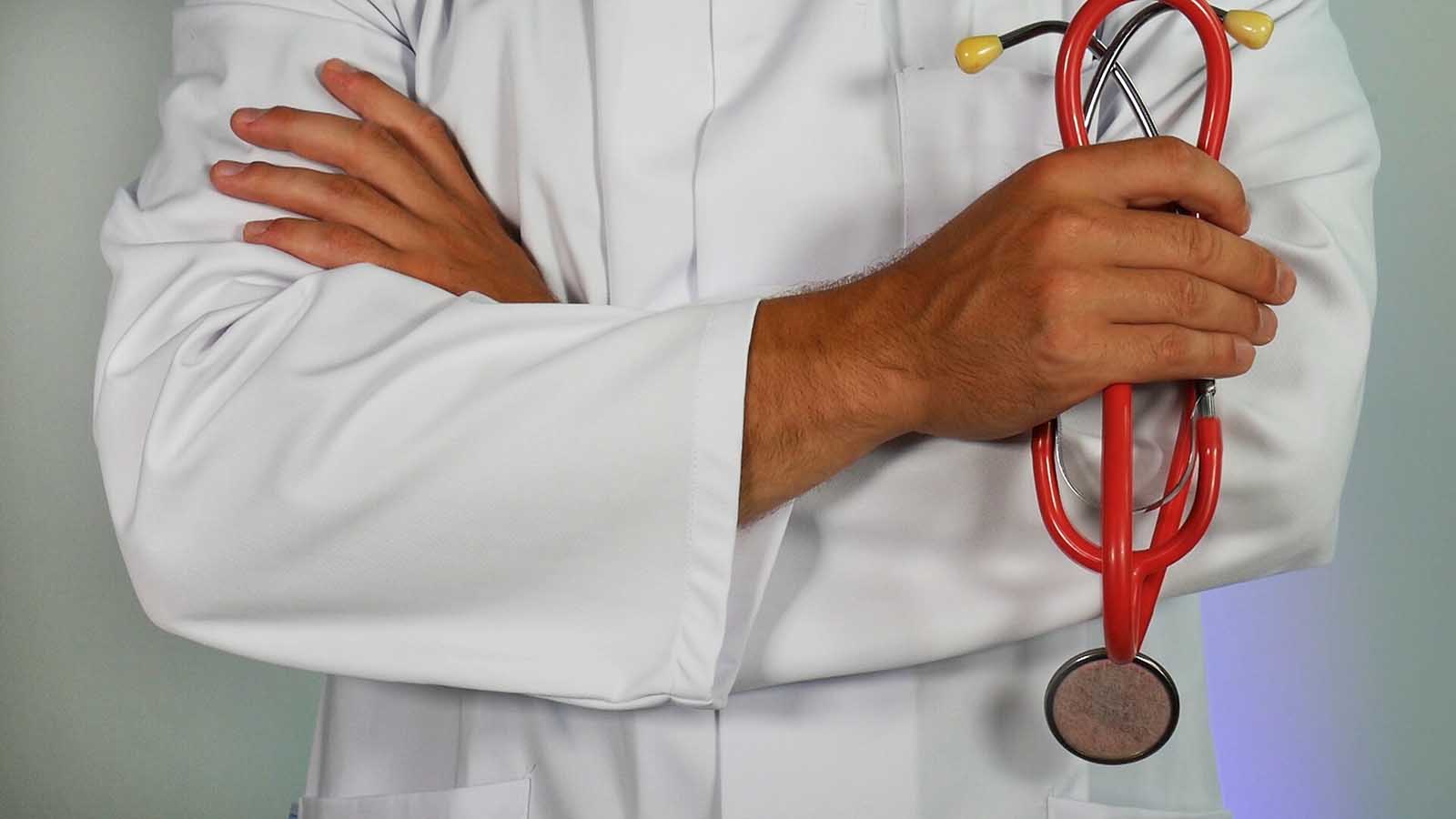 Health care worker with arms crossed.